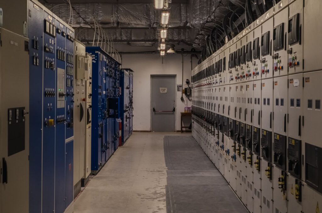 A sophisticated control room filled with electrical panels and equipment for industrial purposes.