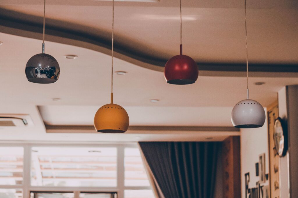 Modern interior with colorful pendant lamps and elegant ceiling design.